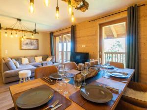 a dining room with a table and a living room at Appartement Les Avanchers-Valmorel, 4 pièces, 8 personnes - FR-1-291-869 in Valmorel