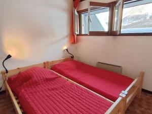 a bedroom with a red bed and a window at Appartement Cauterets, 3 pièces, 6 personnes - FR-1-234-263 in Cauterets