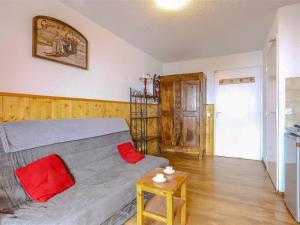 a room with a bed with red pillows and a table at Studio Val Thorens, 2 pièces, 3 personnes - FR-1-637-20 in Val Thorens