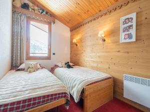2 Betten in einem Zimmer mit Holzwänden in der Unterkunft Appartement Valmorel, 3 pièces, 4 personnes - FR-1-291-871 in Valmorel