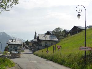 a street in a small town with a hill at Charmant Mazot Savoyard à Hauteluce: Idéal pour Couple, Proche Commerces et Ski, Bien Équipé - FR-1-342-263 in Hauteluce +3 photos