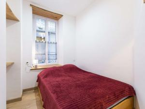 a bedroom with a bed with a red blanket at Appartement Cauterets, 3 pièces, 6 personnes - FR-1-401-230 in Cauterets