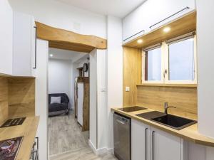 a kitchen with a sink and a counter top at Appartement Cauterets, 3 pièces, 6 personnes - FR-1-401-230 in Cauterets