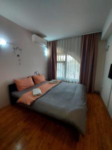 a bedroom with a large bed and a window at The Bulevard Hotel in Skopje