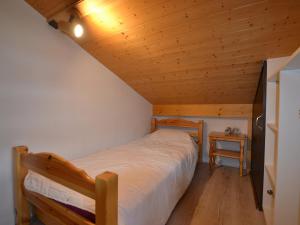 a bedroom with a bed and a wooden ceiling at Appartement Cohennoz, 4 pièces, 5 personnes - FR-1-505-152 in Cohennoz