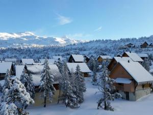 a winter view of a resort with snow covered trees at Studio ski, 4 pers, parking gratuit, proche pistes - FR-1-602-97 in Arette