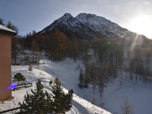 a snow covered mountain with trees and a ski lift at Appartement Montgenèvre, 3 pièces, 8 personnes - FR-1-266-182 in Montgenèvre