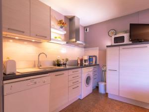 a kitchen with a sink and a washing machine at Confort et Accès Facile : Proche Télécabine, 2 Chambres - FR-1-296-364 in Saint-Lary-Soulan