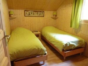 2 Betten in einem kleinen Zimmer mit gelber Bettwäsche in der Unterkunft Chalet Le Biot, 6 pièces, 8 personnes - FR-1-573-52 in Le Biot