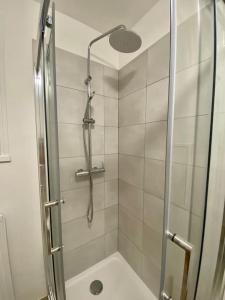 a shower with a glass door in a bathroom at Petit cocon avec Balcon au centre de Marseille in Marseille
