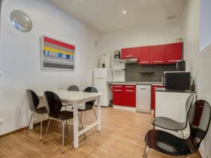 a kitchen with a table and chairs in a room at Appartement Moderne Centre-ville, à Deux Pas de la Plage ! - FR-1-4-619 in Saint-Jean-de-Luz +9 photos