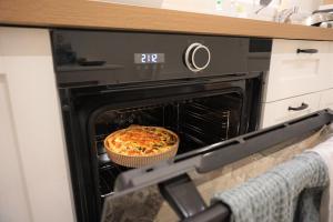 a pizza is sitting inside of an oven at Les Beaux Jours, Tours, le Duplex in Tours