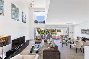 a living room with a couch and a table at ELLE Design Villa by OCvillas in Albufeira