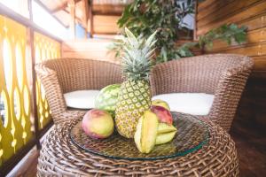 a table with a pineapple and other fruits on it at Hotel Bocas del Toro in Bocas del Toro