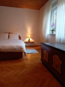 a bedroom with a bed and a window at Riverside Villa Avo - Apartment AVO in Spodnja Idrija