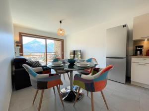 a kitchen and dining room with a table and chairs at Appartement Briançon, 2 pièces, 4 personnes - FR-1-330C-127 in Briançon