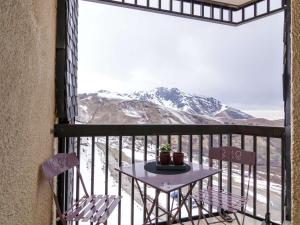 una mesa en un balcón con vistas a la montaña en Appartement Saint-Lary-Soulan, 2 pièces, 4 personnes - FR-1-296-383, en Saint-Lary-Soulan