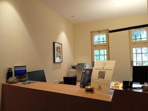 an office with a reception counter with a desk at Guesthouse - Cultural Center Gustav Mahler in Dobbiaco