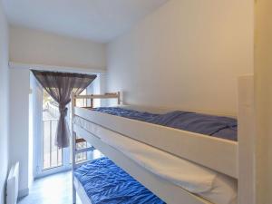 a bedroom with a bunk bed and a window at Appartement Cauterets, 3 pièces, 4 personnes - FR-1-401-240 in Cauterets