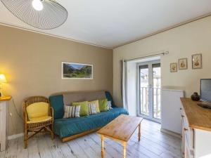 a living room with a couch and a table at Appartement Cauterets, 3 pièces, 4 personnes - FR-1-401-240 in Cauterets