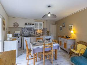 a kitchen and dining room with a table and chairs at Appartement Cauterets, 3 pièces, 4 personnes - FR-1-401-240 in Cauterets