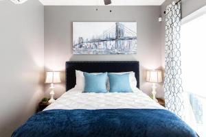 a bedroom with a blue and white bed and a bridge at Professionals-Restaurants-FastWiFi-A C-Desk- Pets in San Diego