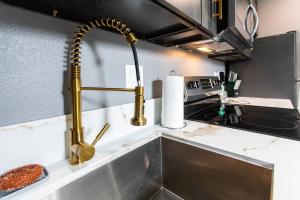 a kitchen with gold faucets on a sink at Professionals-Restaurants-FastWiFi-A C-Desk- Pets in San Diego