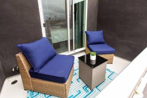 two chairs with blue cushions sitting on a balcony at Professionals-Restaurants-FastWiFi-A C-Desk- Pets in San Diego