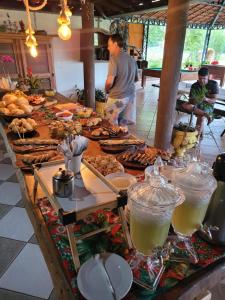 a buffet with many different types of food on a table at Pousada Portal da Serra in São João Batista do Glória