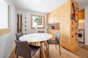 a kitchen and dining room with a table and chairs at Casa Collina 5i-02 in Flims