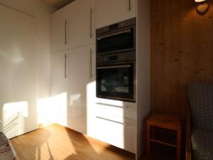 a kitchen with an oven and a tv on a wall at Appartement Montvalezan-La Rosière, 2 pièces, 6 personnes - FR-1-398-540 in La Rosière