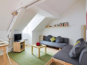 a living room with a couch and a tv at Appartement Cauterets, 2 pièces, 6 personnes - FR-1-401-145 in Cauterets