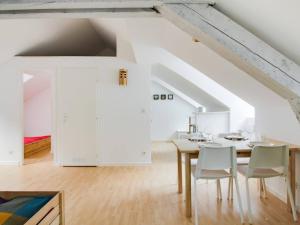 a white dining room with a table and chairs at Appartement Cauterets, 2 pièces, 6 personnes - FR-1-401-145 in Cauterets