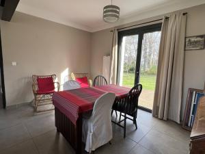 a dining room with a table and chairs and a window at Maison Cambo-les-Bains, 4 pièces, 4 personnes - FR-1-495-48 in Cambo-les-Bains