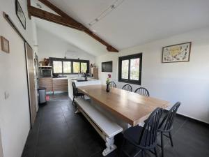 a kitchen and dining room with a wooden table and chairs at Maison Cambo-les-Bains, 4 pièces, 4 personnes - FR-1-495-48 in Cambo-les-Bains