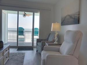 a living room with a couch and a chair at A Beach Dream condo in Carolina Beach