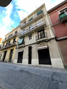 a large building with two garage doors and balconies at Click&Flat Stylish Torrijos in Barcelona