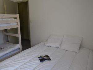 łóżko w pokoju z książką w obiekcie Appartement Montgenèvre, 2 pièces, 6 personnes - FR-1-266-145 w mieście Montgenèvre