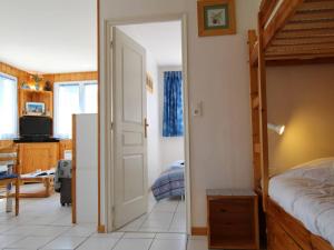 a bedroom with a bed and a open door at Appartement Briançon, 2 pièces, 4 personnes - FR-1-330C-4 in Briançon