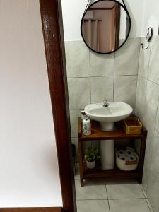 a bathroom with a sink and a mirror at Luar de Araçatiba Suítes in Praia de Araçatiba