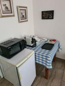 eine Küche mit einem Tisch und einer Mikrowelle in der Unterkunft Hornbill Helipad 1 in Centurion