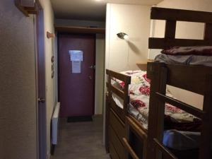 a room with two bunk beds and a purple door at Studio cabine 5 pers, balcon, 80m pistes, animaux ok - FR-1-404-228 in La Mongie +6 photos