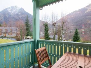 a wooden bench on a porch with a view of a mountain at Maison Cauterets, 4 pièces, 7 personnes - FR-1-401-178 in Cauterets