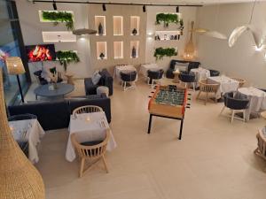 a store with tables and chairs and a chessboard in a room at Golden Tulip Porto-Vecchio in Porto-Vecchio