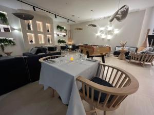 a dining room with a table with wine glasses on it at Golden Tulip Porto-Vecchio in Porto-Vecchio