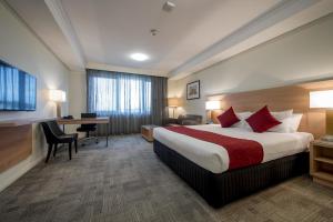 A bed or beds in a room at Bunbury Hotel Koombana Bay