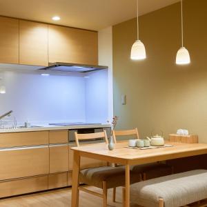 a kitchen with a table and a large screen at 俪居花园酒店Reikyo Garden Hotel in Osaka