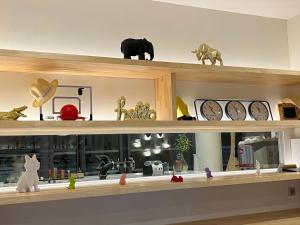 a shelf with clocks and other items on it at Golden Tulip Porto-Vecchio in Porto-Vecchio