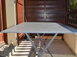 a blue ping pong table sitting on a porch at Appartement calme centre station avec parking - FR-1-593-41 in Les Angles
