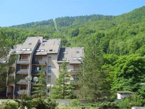 an apartment building in the middle of a mountain at Studio Bagnères-de-Luchon, 1 pièce, 4 personnes - FR-1-313-148 in Luchon